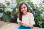 Portrait Of Thai Student University Beautiful Girl Using Her Smart Phone Stock Photo