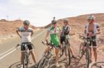 Cyclists On The Road Near Seeheim In Namibia Stock Photo