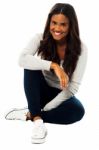 Pretty Girl Sitting On Floor Stock Photo