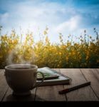 Hot Coffee, Calculator Notebook And Pen On Wooden Table In The M Stock Photo