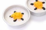 Gold Egg Yolk Threads And Black Bean Top Coconut Sticky Rice Cups On White Floor Stock Photo