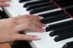 A Woman Playing Piano Stock Photo