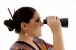 Side Pose Of Female Watching Through Binocular Stock Photo