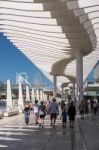 People Walking Under The Modern Pergola In The Harbour Area Of M Stock Photo