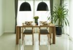 Dining Table And Comfortable Chairs In Modern Home With Elegant Stock Photo