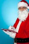 Santa Claus Making Notes In The Wish List Stock Photo