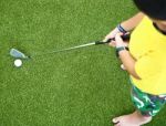 Small Kid Playing Golf Stock Photo