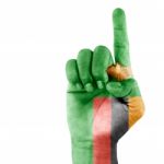 Zambia Flag On Pointing Up Hand Stock Photo