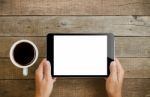 Hand Holding Tablet On Wood Table Stock Photo