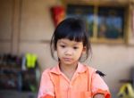 Sad Little Girl Holding Her Face Stock Photo