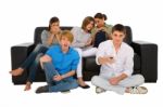 Teenagers holding TV remote Stock Photo