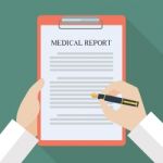 Doctor Hand Writing On Medical Report Stock Photo