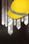 Yellow Hard Hat With Blueprints Stock Photo