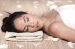 Beautiful Lady With White Flowers In Spa Treatment Stock Photo