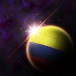 Colombia Flag On 3d Football With Rising Sun Stock Photo