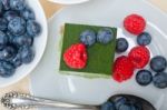 Green Tea Matcha Mousse Cake With Berries Stock Photo