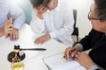 Business People And Lawyers Discussing Contract Papers Sitting A Stock Photo