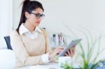 Young Businesswomen Working With Digital Tablet In Her Office Stock Photo