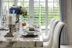 Table Set In White Dinning Room With Chairs Stock Photo