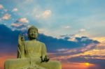 Statue Of Buddha At Peace With Sunset Background Stock Photo