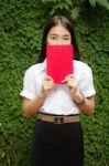 Thai Adult Student University Beautiful Girl Reading Red Book Stock Photo