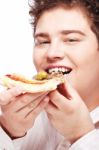 Chubby Boy Eating A Slice Of Pizza Stock Photo