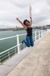 Young African Woman Jumping Stock Photo