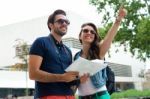 Young Tourist Couple Use Their Map And Pointing Where They Want Stock Photo