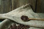 Coffee Beans In Wooden Spoon On Sackcloth Stock Photo