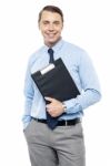 Handsome Smiling Executive Holding Clipboard Stock Photo