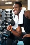 Young African Male Holding Dumbbell Stock Photo