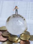 Miniature Traveller Or Backpacker Stand On Globe Of Glass, Euro Stock Photo