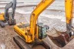 Two Excavators Riding On The Beach Stock Photo