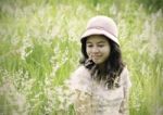 Young Woman On The Meadow With White Flowers On A Warm Summer Da Stock Photo