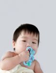 Baby Holding Toys Stock Photo