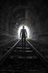 Man In A Tunnel Looking Towards The Light Stock Photo