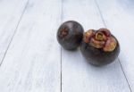 Mangosteen On White Wood Background Stock Photo