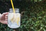 Hand Hold Glass Of Iced Apple Soda Drink Stock Photo