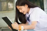 Portrait Of Thai Student Teen Beautiful Girl Using Her Tablet Stock Photo