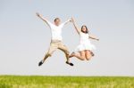 Young Couple Jumping Stock Photo