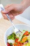 Pretty Young Woman Eating Salad At Home Stock Photo