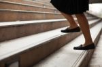 Woman Moving Up Steps Stock Photo