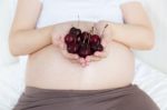 Pregnant Belly With Cherry Stock Photo