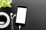 Phone And Headphones On Table Top View Stock Photo