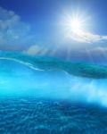 Under Clear Sea Water With Sun Shining Sky And Sand Dune Ground Stock Photo