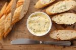 Baguette With Herb Butter And Rosemary Thyme On Rustic Wooden Background Stock Photo