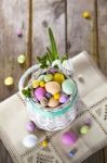 Easter Eggs In The White Basket On Rustic Wooden Background Stock Photo