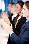 Team Of Four Corporates Applauding Stock Photo