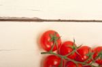 Fresh Cherry Tomatoes On A Cluster Stock Photo