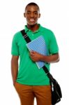 African Male Holding Book And Bag Stock Photo